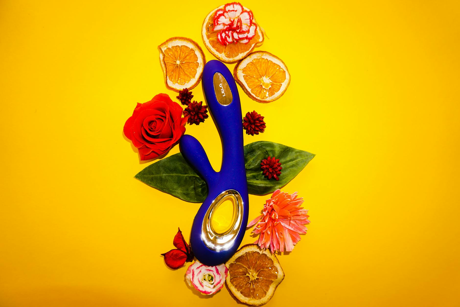 Woman holding blue and pink clitoral vibrators, representing mindful exploration with new partners.